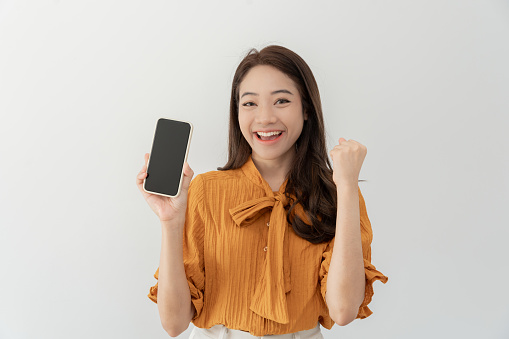 excited young woman play games by mobile phone make winner gesture. female winning mobile gambling. Wow face expression. Esport streaming game online, surprise, gamer, online, earning, new generation.