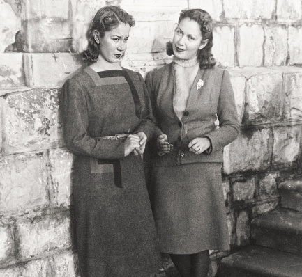 Young Sisters standing near to staircase. 1938.