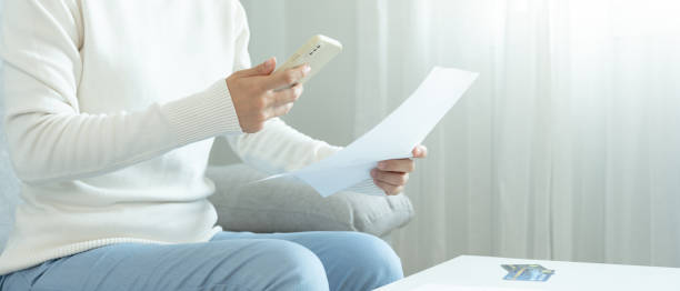 istock woman use phone scan barcode or QR codes to pay credit card bill after receiving document invoice. payment, receive, paying electricity, digital payments, technology, scanning, financial transactions 1620373561