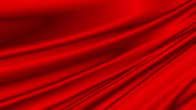 Abstract animated background material of smooth drape red satin fabric