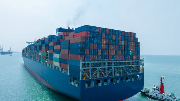 istock Stern ship. Cargo Container Ship carrying container and running with tug boat for import export goods from cargo yard port to custom ocean concept freight shipping 1620396694