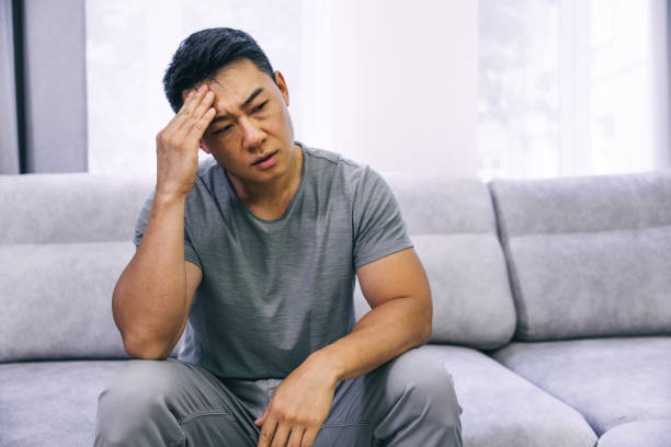 istock Feeling stressed. Frustrated handsome young man touching his head and keeping eyes closed 1620397810