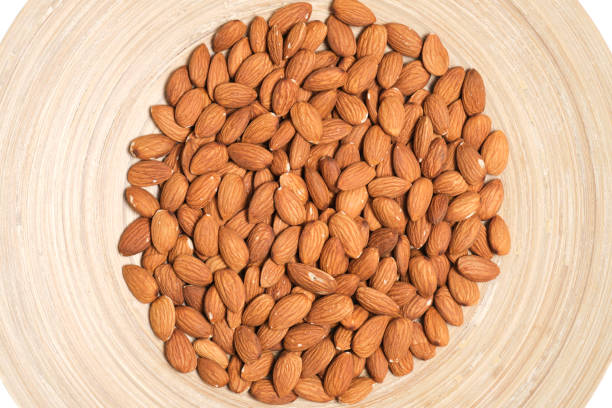 istock Almonds nuts in a wooden plate. 1620408300