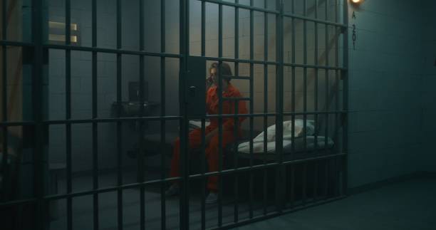 istock Female talking phone in prison 1620419488