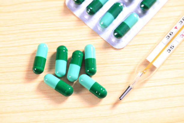istock Pharmacy background. Pills on a banknote isolated on a white background. Different types of capsules on dollars banknote. 1620435385