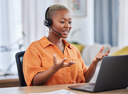 Black woman, call center and consulting on laptop in customer service, support or telemarketing at home. African female person or consultant agent talking on computer with headphones in online advice