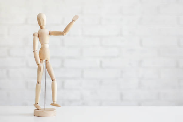 istock wooden human figure showing hello sign over white brick wall background 1620461233