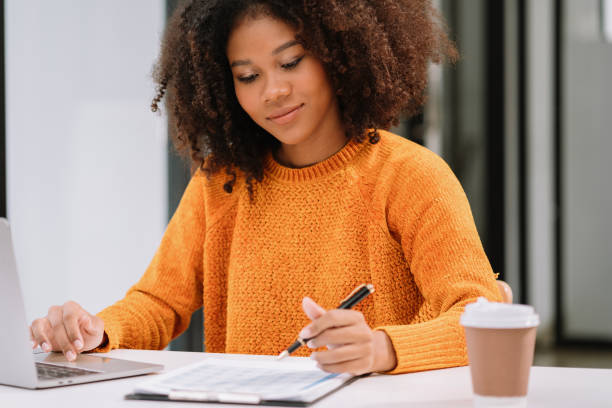 istock Female writes information businessman working on laptop computer writing business plan while sitting in office. 1620462382