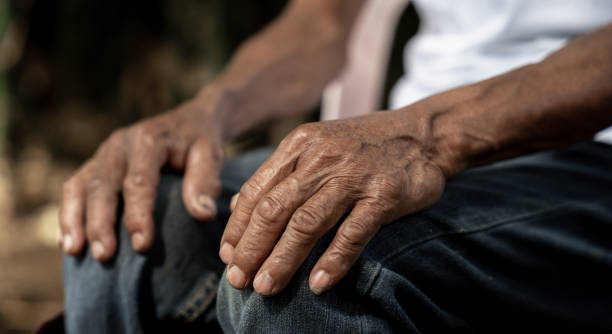 istock Close up of elderly oldman hands on wooden table. 1620463488
