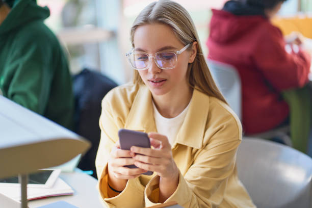 istock Girl student using mobile phone looking at cellphone sitting in university. 1620472587