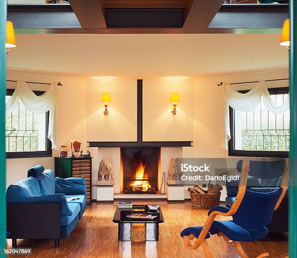 Living Room With Fireplace Parquet Floor Blue Sofas And Chair Stock Photo - Download Image Now