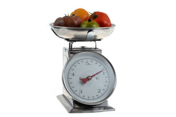 istock Weigh tomatoes close-up on a white background 1620480508