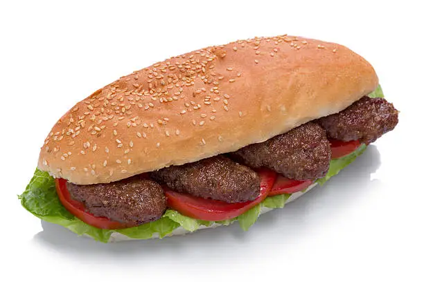 Sandwich with meatballs on white background.