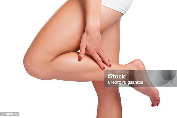 A Woman Touching Her Calf On Her Left Leg Stock Photo - Download Image Now - Adult, Cramp, Cut Out