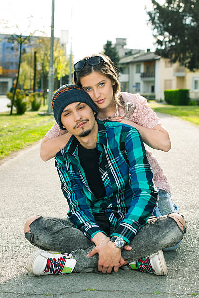 istock Young couple sitting on the sidewalk 162049050