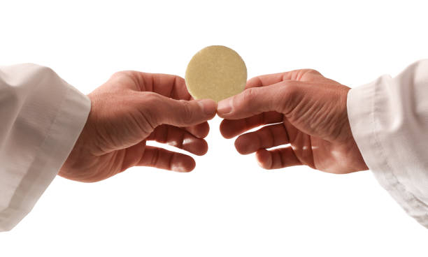 istock Hands of a priest consecrating a host with isolated background 1620495515