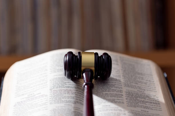istock Holy bible book and judge's gavel on table background. Judicial system, constitution, democracy, rule of law. There are no people in the photo. There is free space to insert. 1620496600