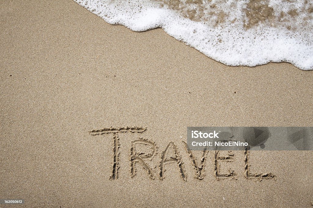 Travel Handwriting on the sand with a wave and sunlight Thailand Stock Photo