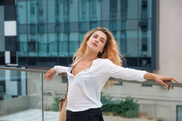 istock Woman leaned on the railing and opened her arms 1620507925