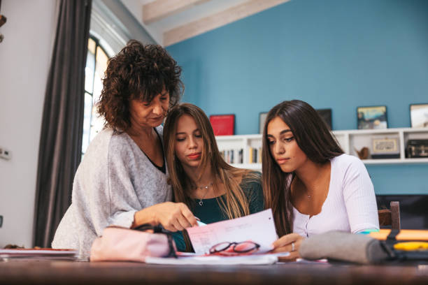 istock Mother and daughters studying together 1620534435