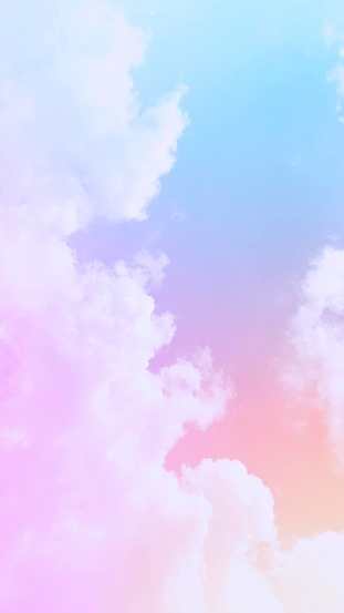 Rainbow sky background, soft pastel colors and gentle misty clouds.  Subtly harmonious gradients of blue, purple, orange, pink, bright and beautiful.