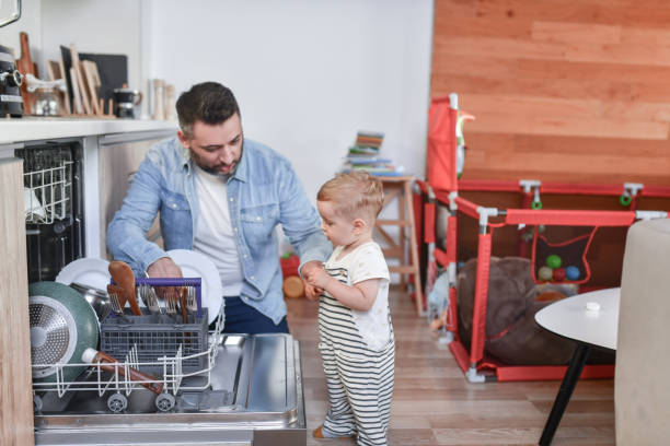 Dishwasher Properties Explained By Father To Toddler Son stock photo