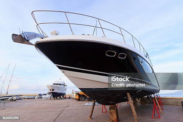 Luxury Motor Yacht Beached For Annual Check Stock Photo - Download Image Now - Examining, Nautical Vessel, Boat Deck