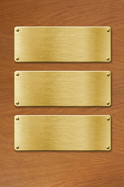 istock three golden metal plates over wood texture 162055510
