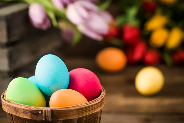 Colorful Easter eggs on wooden background. They can be painted in various colors and can be given on Easter or springtime. Decorating Easter Eggs is fun and creative activity which you can do with your family. Colored Easter Egg is a universal symbol of Easter.