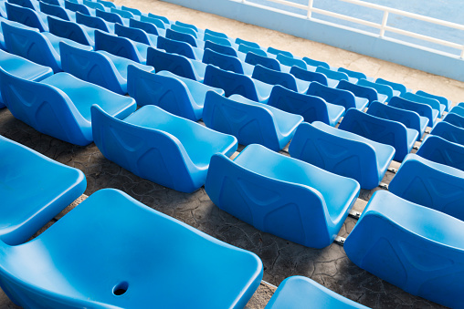 Blue stadium Chair in bleachers soccer stadium. Sport, relaxing and cheering concept.