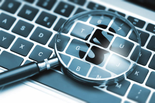 istock Magnifying glass on computer keyboard shows a large paragraph symbol 1620581065