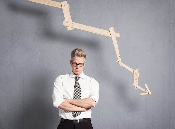 istock Displeased businessman in front of graph with negative trend. 162058188