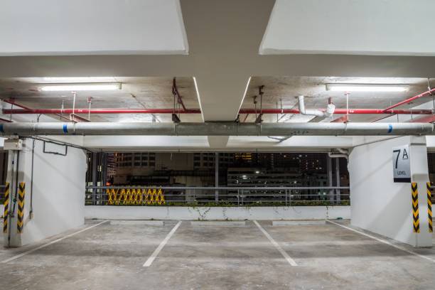 istock Parking garage interior in residential building at night with lighting. 1620593753