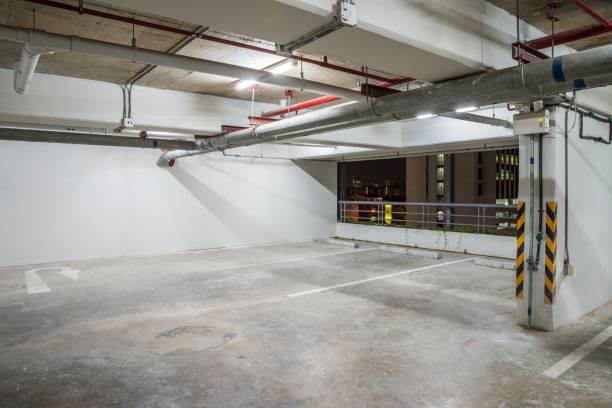 istock Parking garage interior in residential building at night with lighting. 1620593760