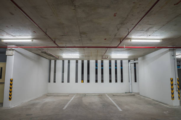 istock Parking garage interior in residential building at night with lighting. 1620594283