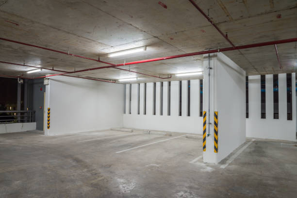 istock Parking garage interior in residential building at night with lighting. 1620595381