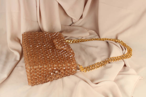 istock Handmade mink bead bag on cream fabric. 1620610140