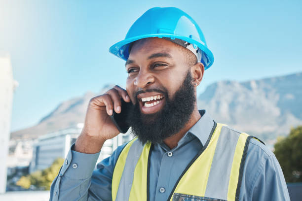 istock Man, construction and worker with phone call in city for civil engineering, building site and industry. Face of happy african male architect, manager or talking on smartphone for property development 1620613418