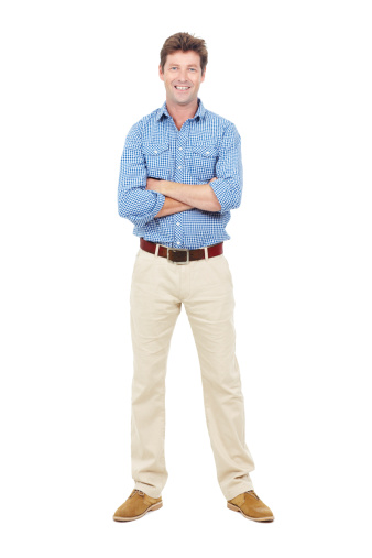 Friendly adult male with his arms folded smiling at the camera - isolated on white