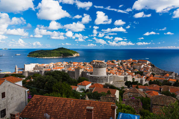 The old town of Dubrovnik and Roklum Island seen from the Mount Srdj in Croatia Dubrovnik is a charming coastal city in Croatia known for its medieval Old Town and beautiful sea views. The city has impressive walls and fortresses, and it was featured in "Game of Thrones." It's a top destination for history, culture, and beach lovers alike. fort minceta dubrovnik stock pictures, royalty-free photos & images
