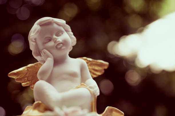 istock Cute angelic cupid statue with beautiful bokeh background. 1620634133