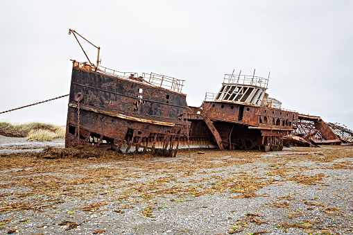 Shipwreck called Amadeo on the  coast of Magellan Strait, rusty warship wreck, Tierra Del Fuego, Chile