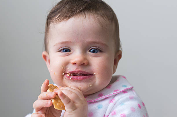 istock Messy, happy little girl eating a cookie 162064291