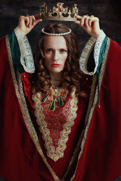 istock medieval queen in red dress with crown 1620661587
