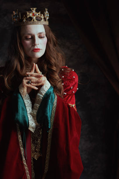 istock medieval queen in red dress with white makeup and crown 1620661595