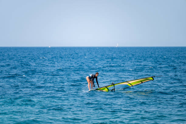 istock Young girl windsurfing in a blue ocean 1620664760