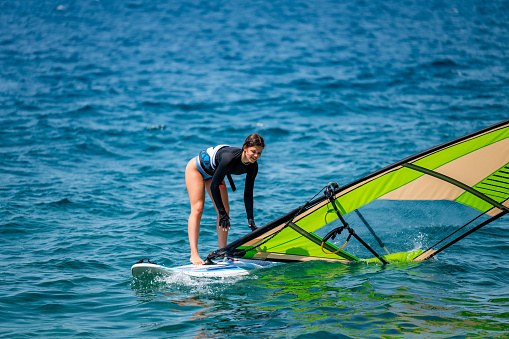 Woman learning windsurfing at the Markkleeberger Lake near Leipzig