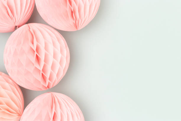 istock Pink tissue paper balls on a blue background. 1620665867