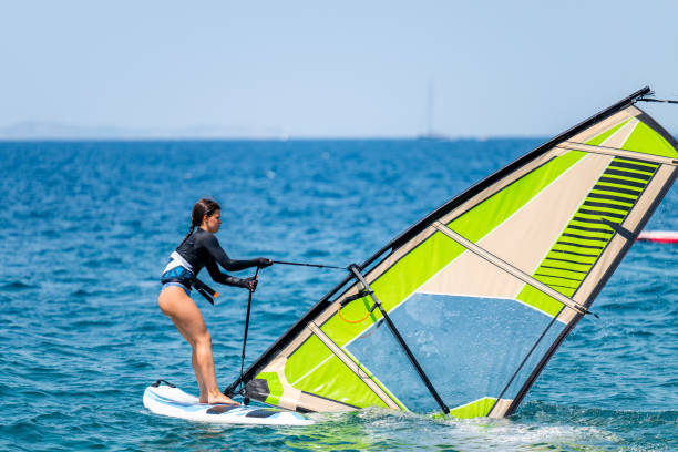 istock Young girl windsurfing in a blue ocean 1620666917
