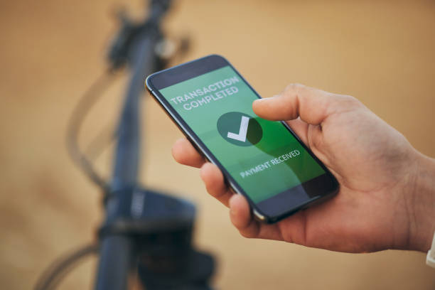 istock Hands, phone screen and payment notification for transaction, ecommerce or banking outdoor. Fintech, smartphone and person on app for online shopping, internet sales or check mark for digital finance 1620685655